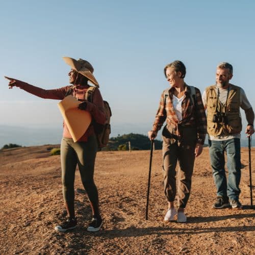 photo of a tour guide with a couple hiking